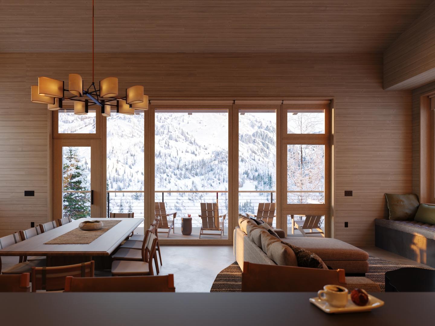 Cozy living room with large windows, mountain view, and modern furnishings.