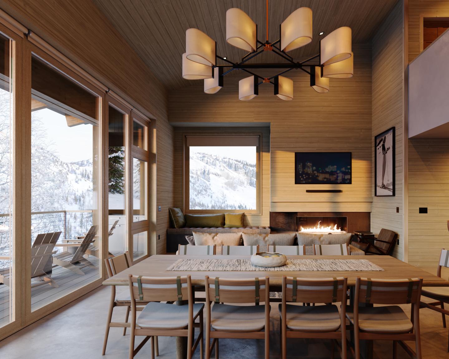 Cozy dining room with a large table, fireplace, and mountain view through glass doors.