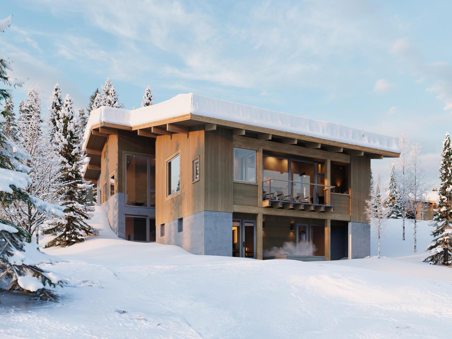 Modern cabin in snowy landscape, surrounded by trees under a blue sky.